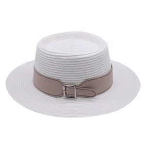 Close-up detail of the stylish white flat-top straw hat featuring a beige leather belt and metal buckle.