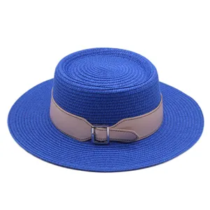 Blue flat top straw hat with stylish leather belt buckle for summer beach vacation and daily sun protection.