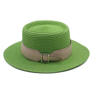 Green flat top straw hat detail, featuring a chic beige leather belt and metal buckle.