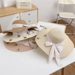 Women straw sun hat wide brim summer beach hat with ribbon butterfly embroidery detail close up