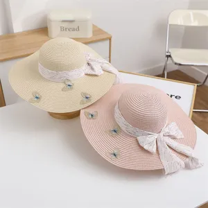 Women wide brim straw sun hat with ribbon bow and butterfly embroidery for summer beach vacation.