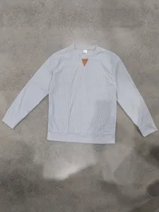 Men's casual long sleeve corduroy crewneck sweatshirt with triangle patch detail.