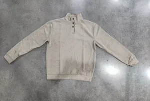 Detail shot of men's textured mock neck half button long sleeve casual sweatshirt fabric.