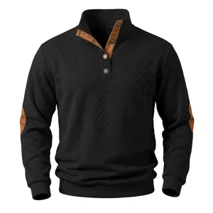 Detailed view of black stand collar sweater with brown leather patch and metal buttons.