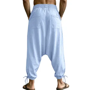 Men's casual linen harem pants with back pockets and drawstring cuffs in light blue.
