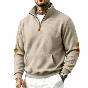 Close-up detail of men's half-zip mock neck sweatshirt with grid texture and elbow patches.