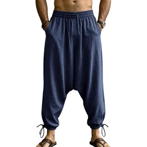 Detailed view of men's casual linen harem pants in dark blue with elastic drawstring waist.