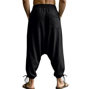 Detailed back view of black linen drop crotch harem pants featuring dual rear pockets.