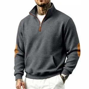 Detail view of men's quarter zip waffle knit sweatshirt with contrast elbow patches and pockets.
