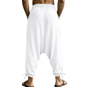 Back view detail of casual white linen harem pants with elastic waist and tie cuffs.