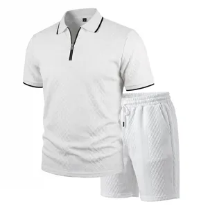 Detail shot of the textured white polo shirt and shorts set showing the zipper and collar.