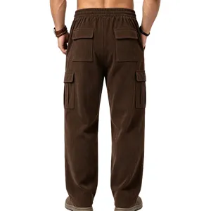 Back view of men's brown corduroy cargo pants with multiple pockets and drawstring waist.
