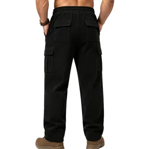 Men's black corduroy cargo pants detail view showing utility pockets and back waistline.
