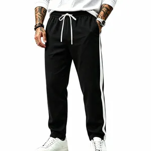 Men casual loose sweatpants featuring contrast side stripes and adjustable drawstring.