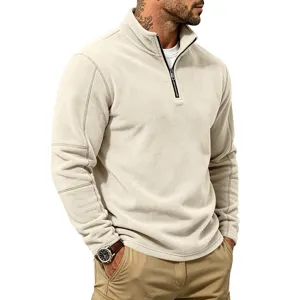 Close-up of men's half-zip fleece pullover in beige with collar and zipper detail.