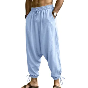 Men light blue linen harem pants detail featuring elastic drawstring waist and cuffed ankles.