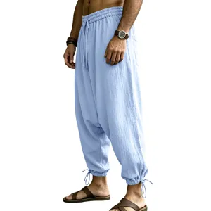 Detail view of men casual linen harem pants in light blue with drawstring waist and cuffs.
