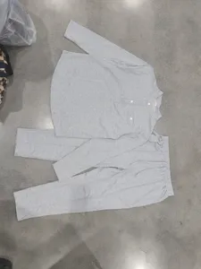 Grey long sleeve Henley shirt and straight pants set detail view, showing soft fabric texture.