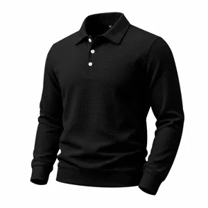 Detailed view of the black waffle knit texture, long sleeves and collar of the casual polo.