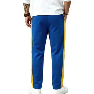 Detail view of men's casual blue sweatpants featuring striking yellow side stripes.