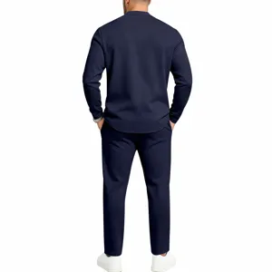 Detailed view of the men's casual navy blue long-sleeve henley shirt and loose trousers set.