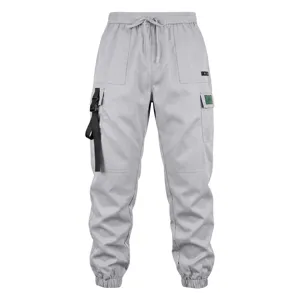 Grey cargo pants detail showcasing multiple utility pockets, drawstring waist and strap.