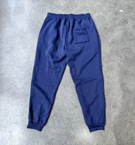 Dark blue fleece sweatpants detail, comfortable loose fit winter joggers with elastic cuff.