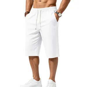 Close-up detail of men's white textured casual shorts with elastic drawstring waist and pockets.