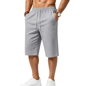 Close-up view of textured grey casual shorts for men, featuring elastic drawstring waist and side pockets.