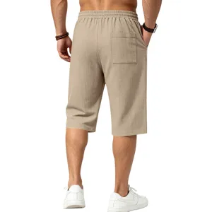 Men's casual linen-feel 7-length shorts featuring textured fabric and elastic waist for daily wear.