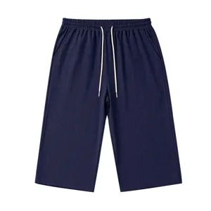 Men's navy blue casual knit textured 3/4 shorts with adjustable drawstring waist details.