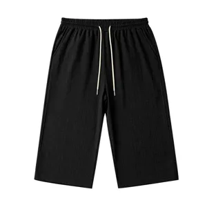Men's black casual 7-point shorts with elastic drawstring waist and knit texture fabric detail.