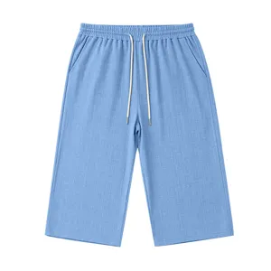 Close-up view of men casual textured 3/4 shorts detail showing elastic waistband and drawstring.
