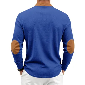 Back detail of blue waffle knit long sleeve henley shirt with brown elbow patches.