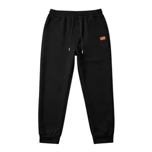Men's black textured casual sports sweatpants detail featuring elastic waistband and cuffs.