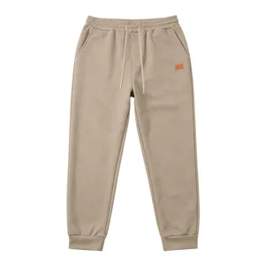 Detailed view of casual men's textured sweatpants with adjustable drawstring and ribbed cuffs.
