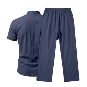 Details showing the back view of the dark blue linen short sleeve shirt and long pants set.