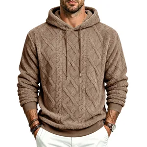 Close-up detail of plush sherpa fleece cable knit hoodie, textured fabric and drawstring hood.