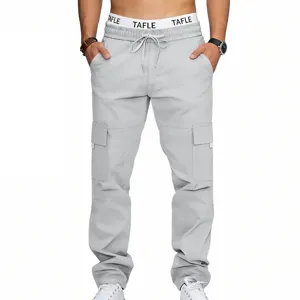 Detailed view of light gray men's cargo pants with multi pockets, drawstring and elastic waist.