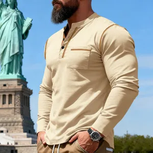 Detailed view of men's casual long sleeve henley shirt with contrast stitching and pocket.