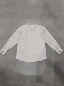 Detail back view of casual solid color long sleeve shirt showing fabric texture and neat collar.