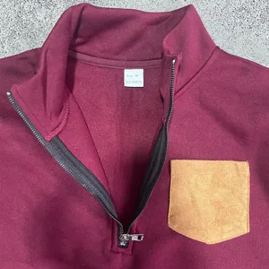 Close up detail of mens quarter zip fleece sweatshirt collar with chest pocket and size tag.
