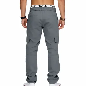 Details view of men's grey cargo pants, featuring multiple pockets and elastic waistband.