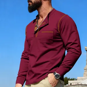 Detailed view of men's long sleeve stand collar shirt featuring contrast stitching and chest pocket.