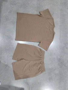 Detailed view of men's summer textured short sleeve and shorts set in casual loose fit.