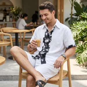 Detail shot of men's summer linen short sleeve shirt and shorts set in white with black stripes.