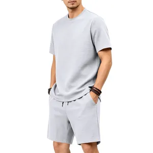 detail view of men light grey textured short sleeve t shirt and casual shorts outfit