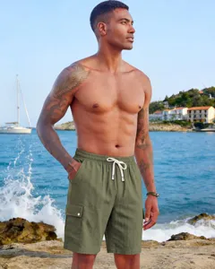 Outdoor scene featuring men's olive green cargo shorts with multi-pockets and drawstring waist.