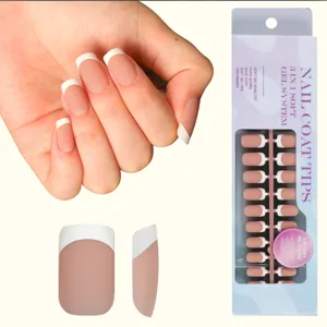 Detail view of French manicure press-on nail tips with packaging box and hand display.