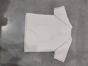 Waffle knit short sleeve detail with contrast stitching and raglan shoulder design.